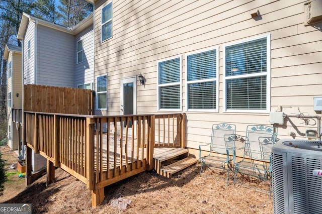 wooden deck with central AC unit and fence