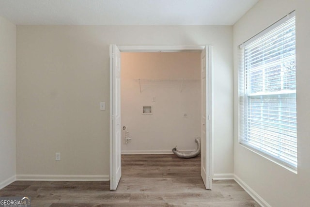 11139 Silver Aspen Ct, Hampton, GA 30228 - laundry room with plenty of natural light and wood finished floors