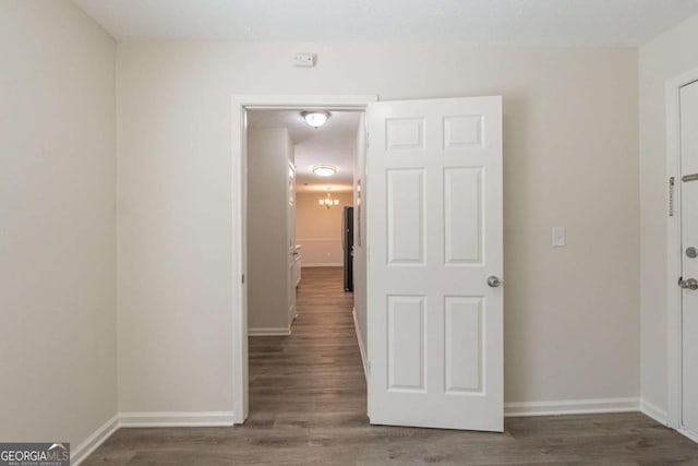 11139 Silver Aspen Ct, Hampton, GA 30228 - hallway with baseboards and wood finished floors