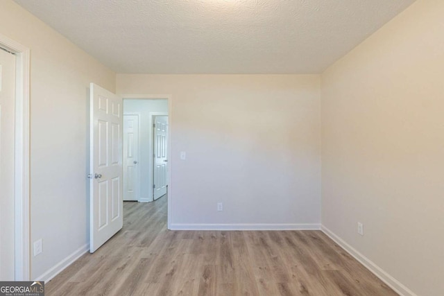 11139 Silver Aspen Ct, Hampton, GA 30228 - unfurnished room with light wood finished floors and a textured ceiling