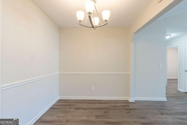 11139 Silver Aspen Ct, Hampton, GA 30228 - empty room featuring a chandelier and wood finished floors