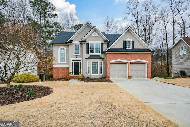 traditional-style home with brick siding, stucco siding, a shingled roof, a garage, and driveway