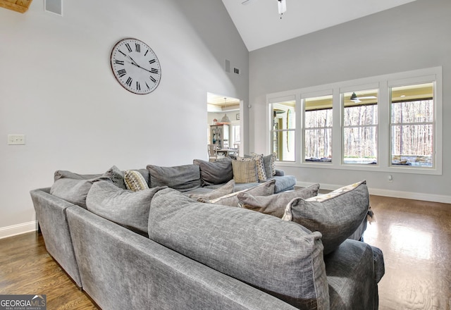 living room with high vaulted ceiling, wood finished floors, a ceiling fan, and baseboards