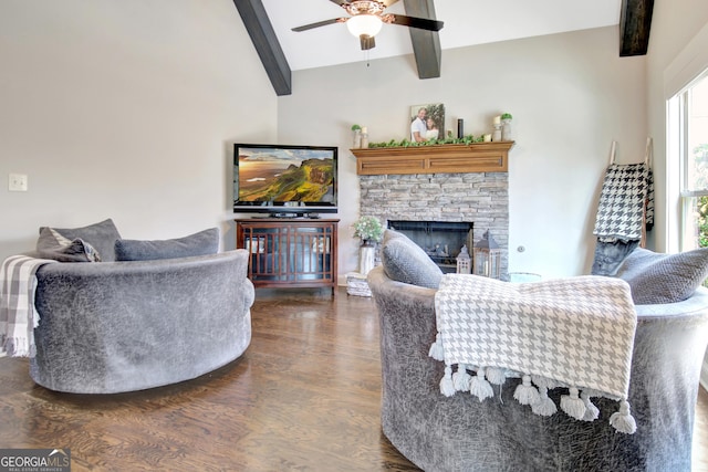 living area featuring dark wood-type flooring, a fireplace, lofted ceiling with beams, and ceiling fan