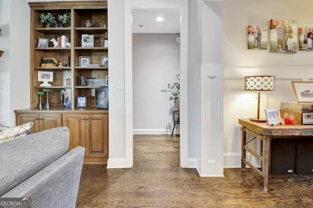 interior space featuring dark wood-type flooring and baseboards