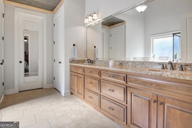 bathroom with double vanity, tile patterned flooring, and a sink