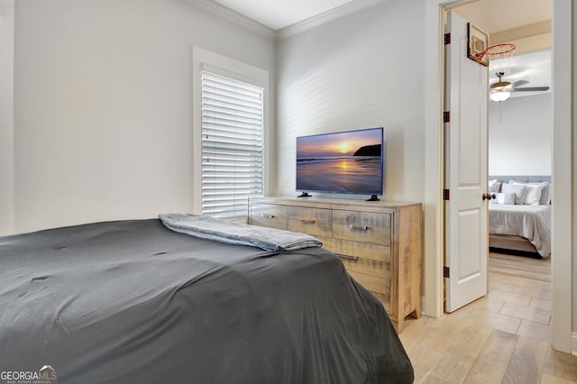 bedroom with ornamental molding and light wood-style floors