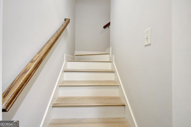 stairway with wood finished floors