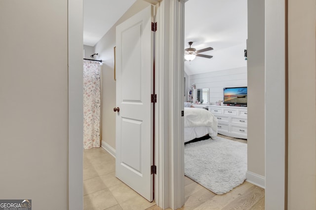 ensuite bathroom with baseboards, a shower with shower curtain, ceiling fan, and ensuite bath