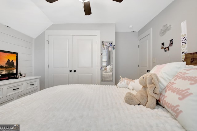 bedroom with vaulted ceiling, a closet, and a ceiling fan