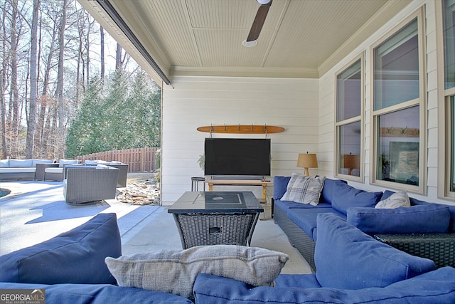 view of patio / terrace with a ceiling fan, fence, and an outdoor living space