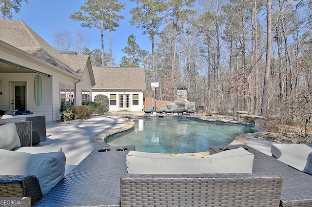 pool featuring an outdoor hangout area, a patio, and french doors