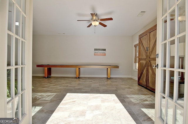 unfurnished room with french doors, a ceiling fan, visible vents, and baseboards