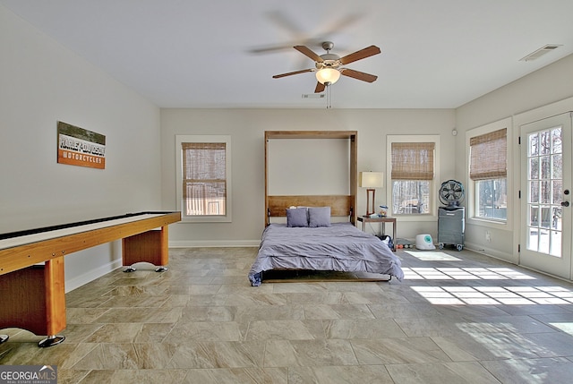 bedroom featuring access to exterior, multiple windows, and visible vents