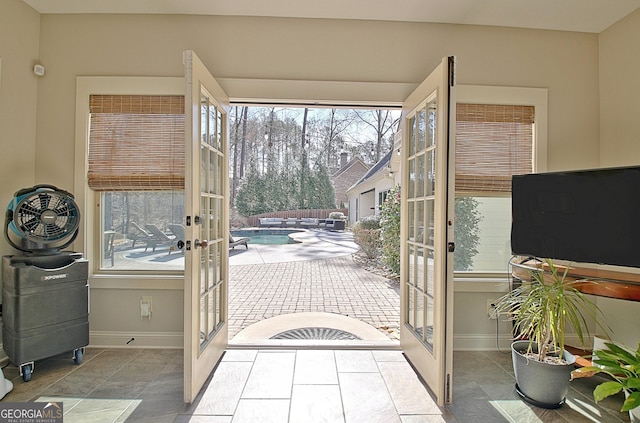 doorway to outside with baseboards and french doors