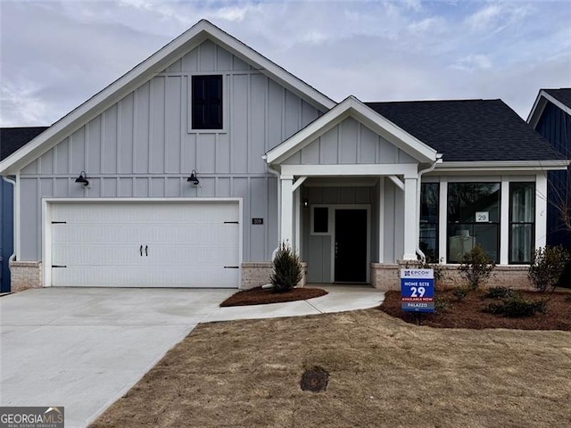 modern inspired farmhouse with driveway, roof with shingles, board and batten siding, and brick siding