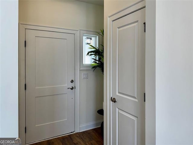 entryway featuring dark wood-style floors and baseboards