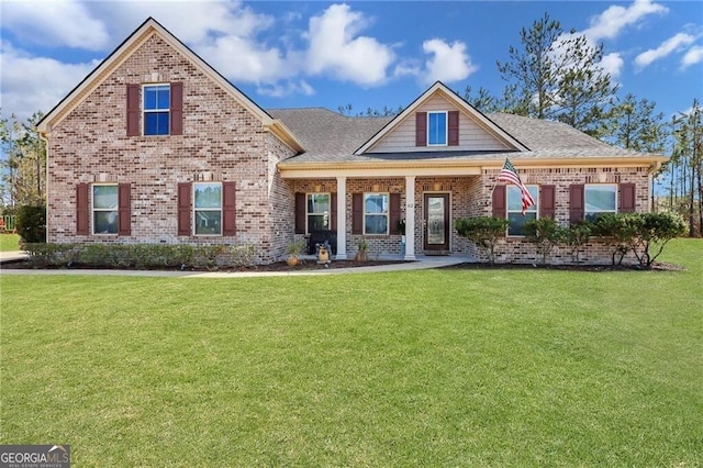 craftsman house featuring a porch, brick siding, and a front lawn