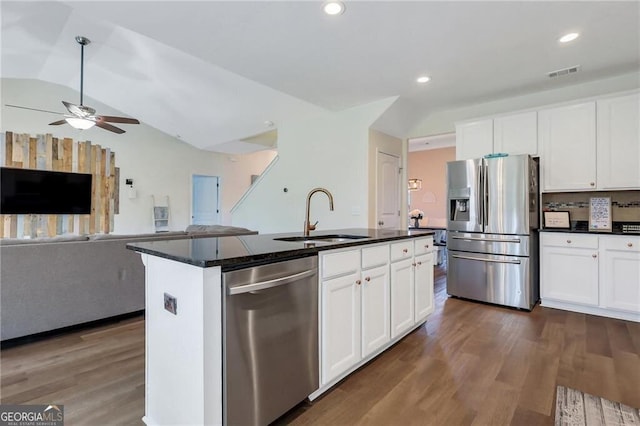 kitchen featuring visible vents, appliances with stainless steel finishes, open floor plan, dark wood-type flooring, and a sink