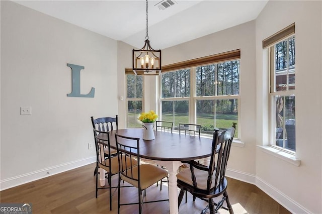 dining area with a notable chandelier, dark wood-style flooring, visible vents, and baseboards