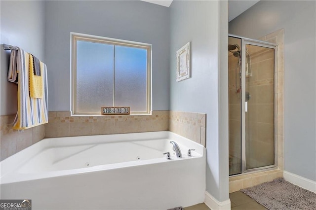 full bath with a wealth of natural light, a shower stall, and a bath