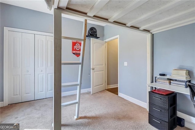 bedroom with carpet floors, a closet, and baseboards