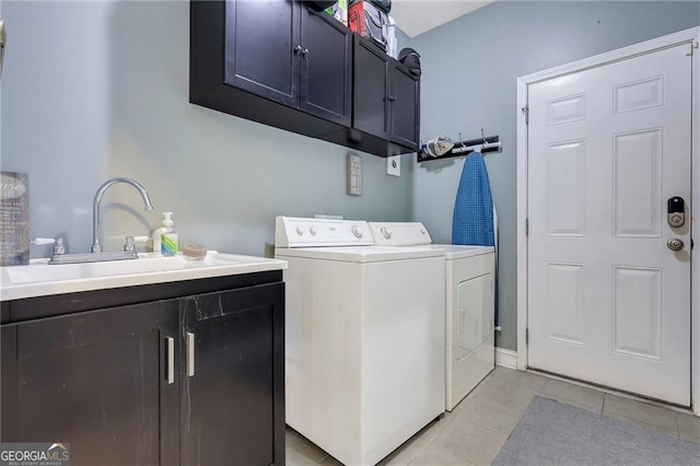 laundry room featuring light tile patterned flooring, cabinet space, a sink, and separate washer and dryer