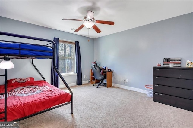 carpeted bedroom featuring ceiling fan, visible vents, and baseboards