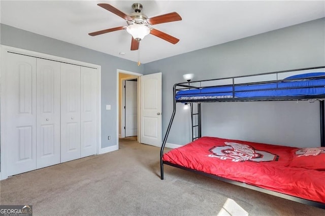 bedroom featuring carpet floors, ceiling fan, baseboards, and a closet