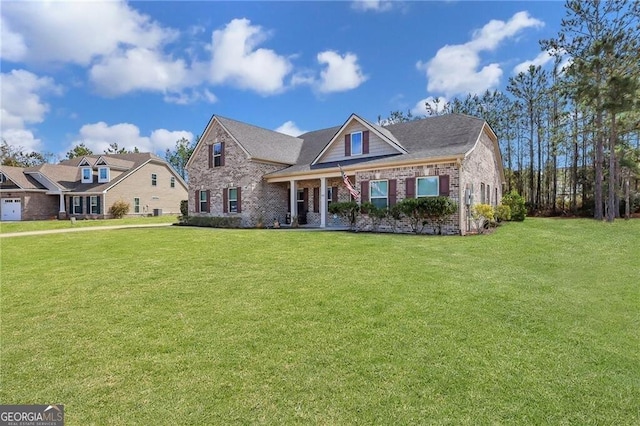 view of front of home with brick siding and a front yard