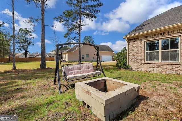 view of yard with a fire pit and fence