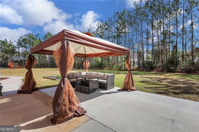 view of patio with outdoor lounge area, a playground, and a gazebo