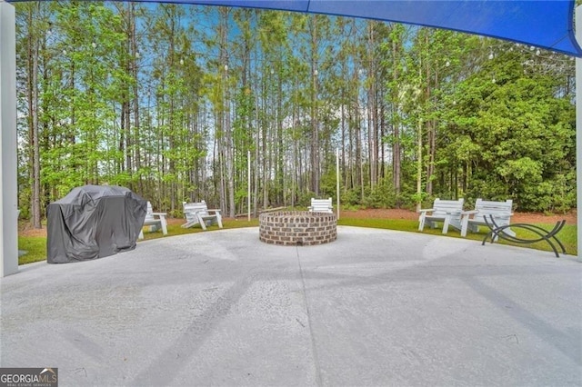 view of property's community with a fire pit and a patio area