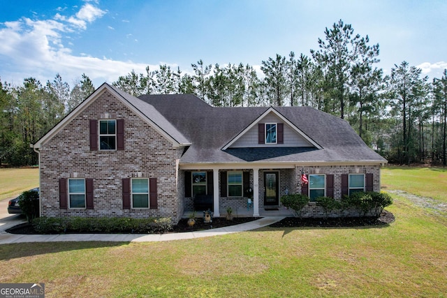 view of front facade with a front lawn and brick siding