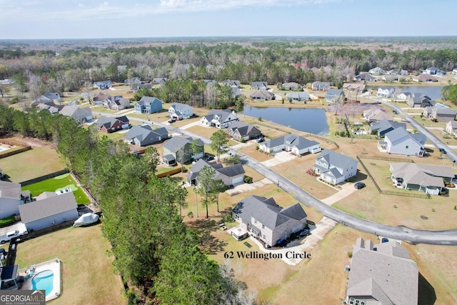 drone / aerial view featuring a water view and a residential view