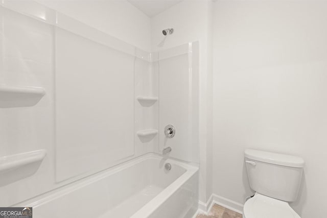 bathroom featuring baseboards and toilet