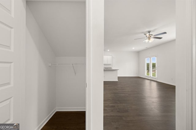 interior space featuring ceiling fan and dark wood finished floors