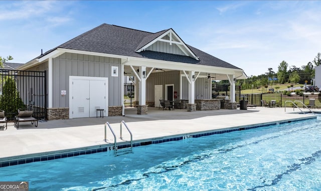 exterior space with a patio area, fence, a ceiling fan, and an outbuilding