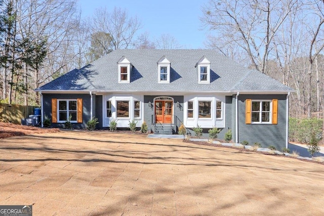 cape cod home with a shingled roof