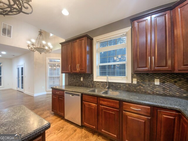 kitchen featuring visible vents, dishwasher, a healthy amount of sunlight, light wood-style floors, and a sink