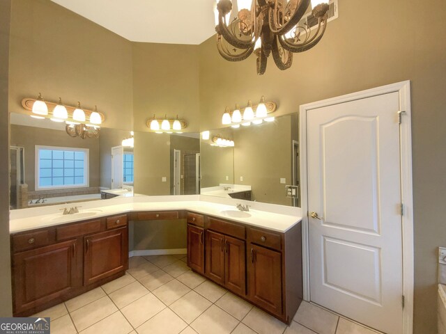 full bath with a shower with door, tile patterned flooring, a high ceiling, vanity, and a notable chandelier