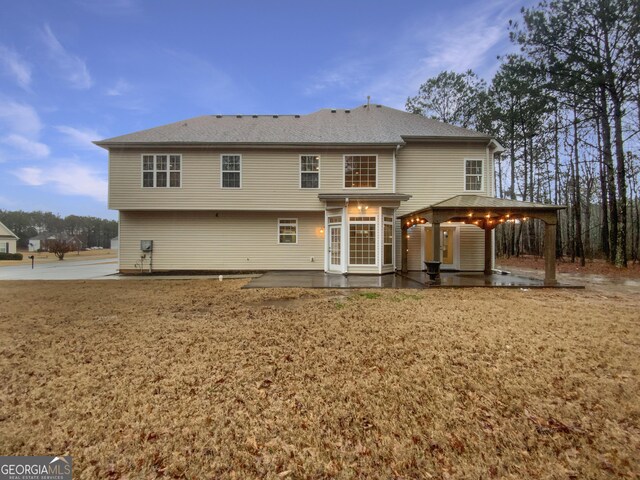 rear view of property featuring a patio