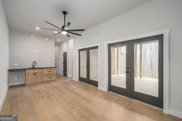 544 Lemmon Ln, Ellijay, GA 30540 - kitchen featuring decorative backsplash, dark countertops, french doors, light wood-type flooring, and a sink