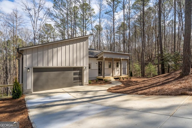 544 Lemmon Ln, Ellijay, GA 30540 - view of front facade with a garage, driveway, a porch, and board and batten siding