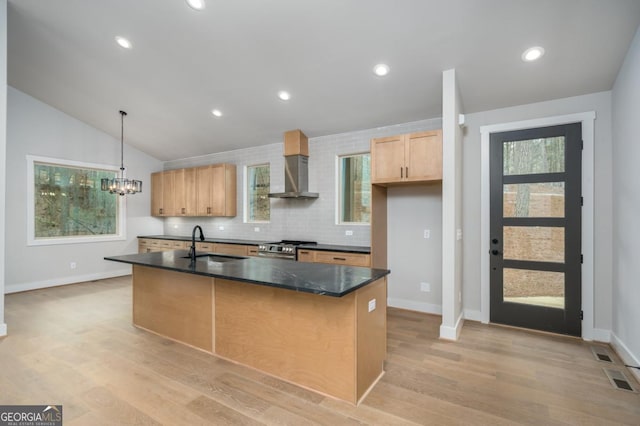 544 Lemmon Ln, Ellijay, GA 30540 - kitchen with stainless steel gas stove, light wood finished floors, visible vents, wall chimney exhaust hood, and a sink