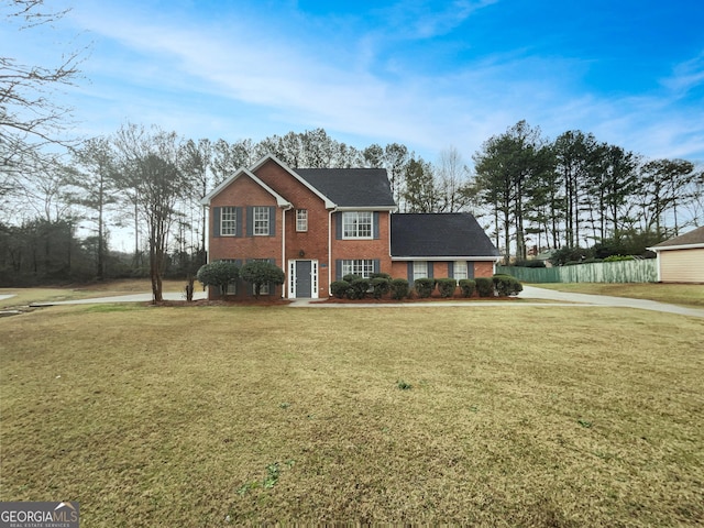 view of front of property with a front lawn and brick siding