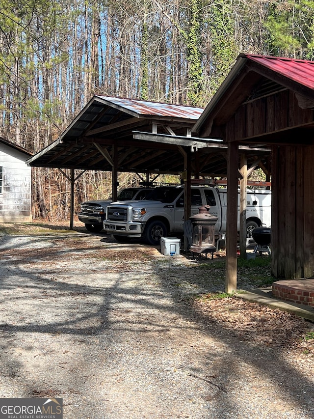 view of parking with a carport and driveway