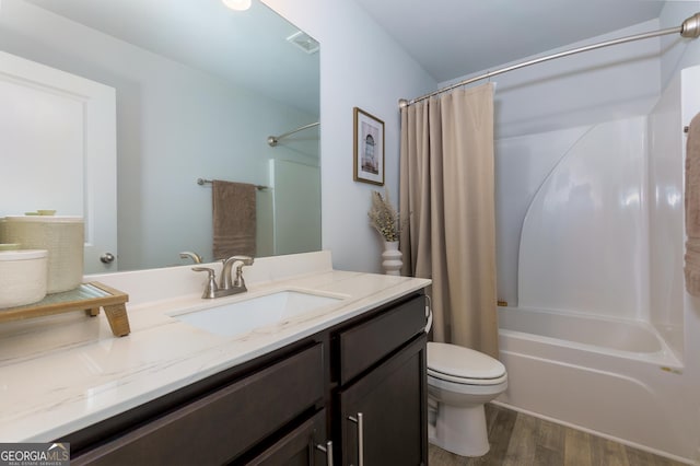 5620 Berney Cir, Powder Springs, GA 30127 - bathroom featuring shower / bath combination with curtain, visible vents, toilet, vanity, and wood finished floors