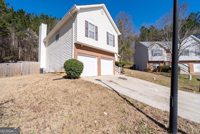 2860 River Close Dr, Decatur, GA 30034 - view of front of property featuring brick siding, a garage, driveway, and a chimney
