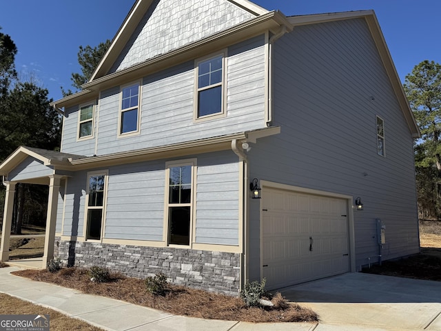 view of front of house featuring stone siding and an attached garage